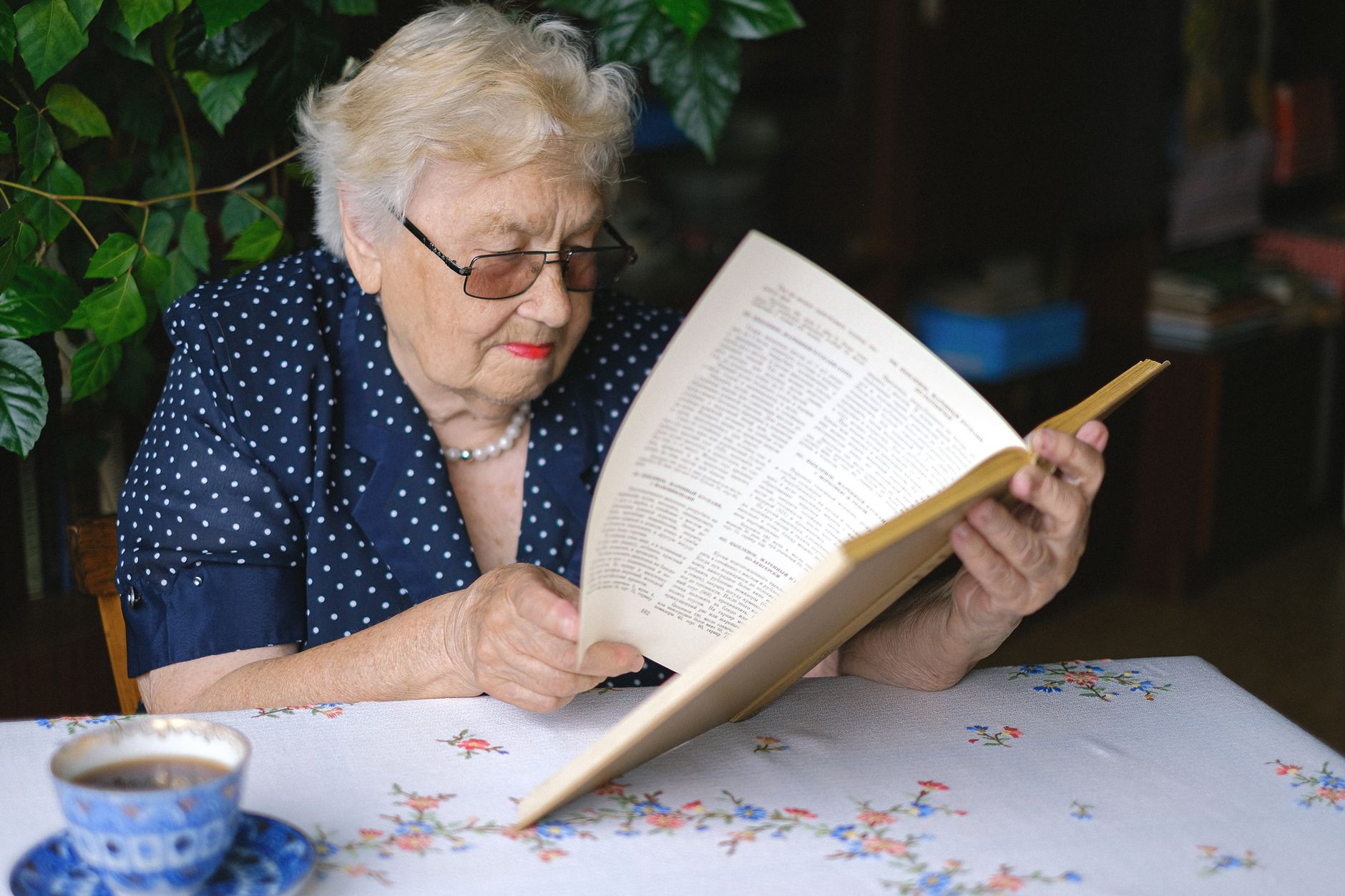 An older adult reading — central vision protected by early detection.