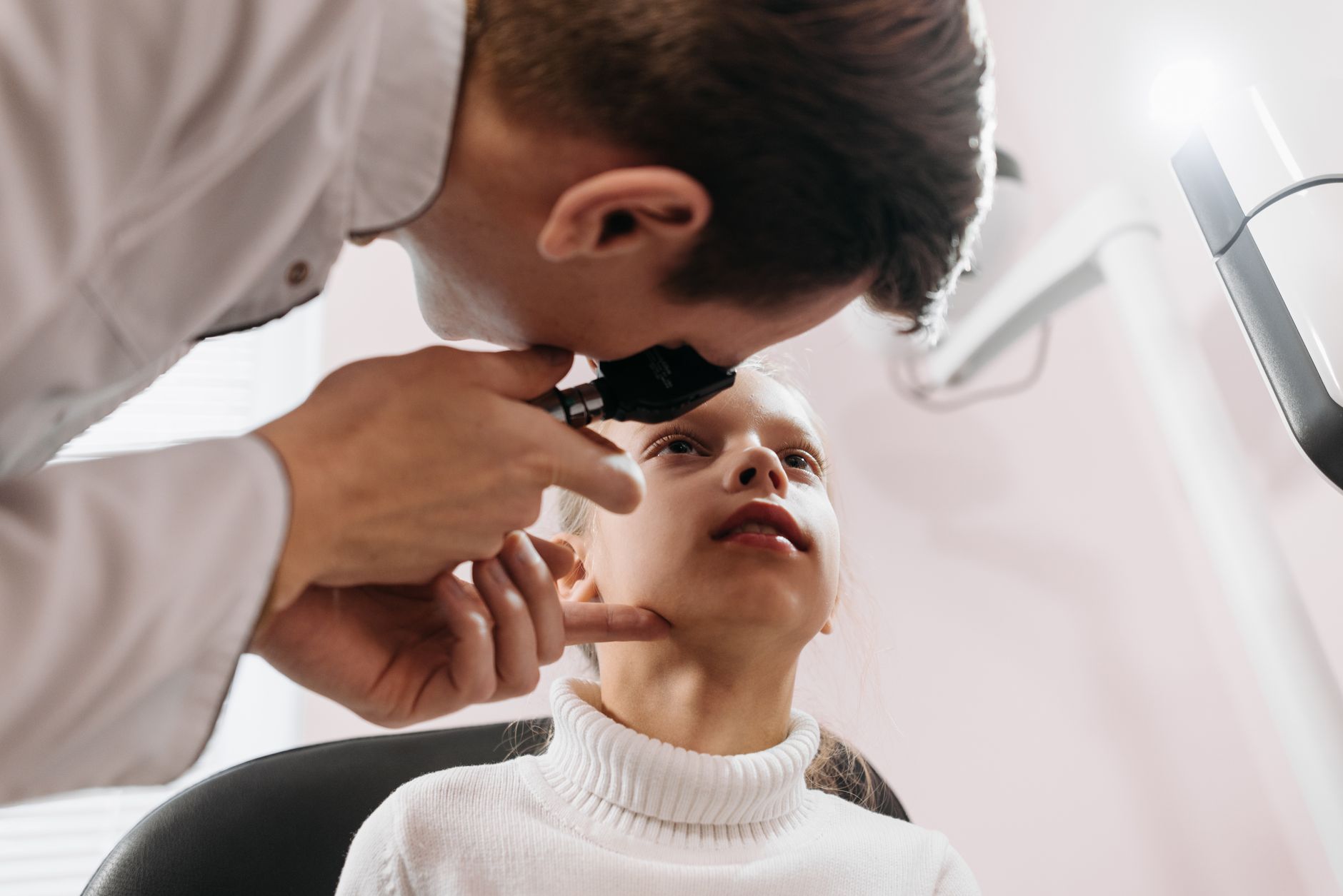 Eye care professional examining a patient during a retinal screening.